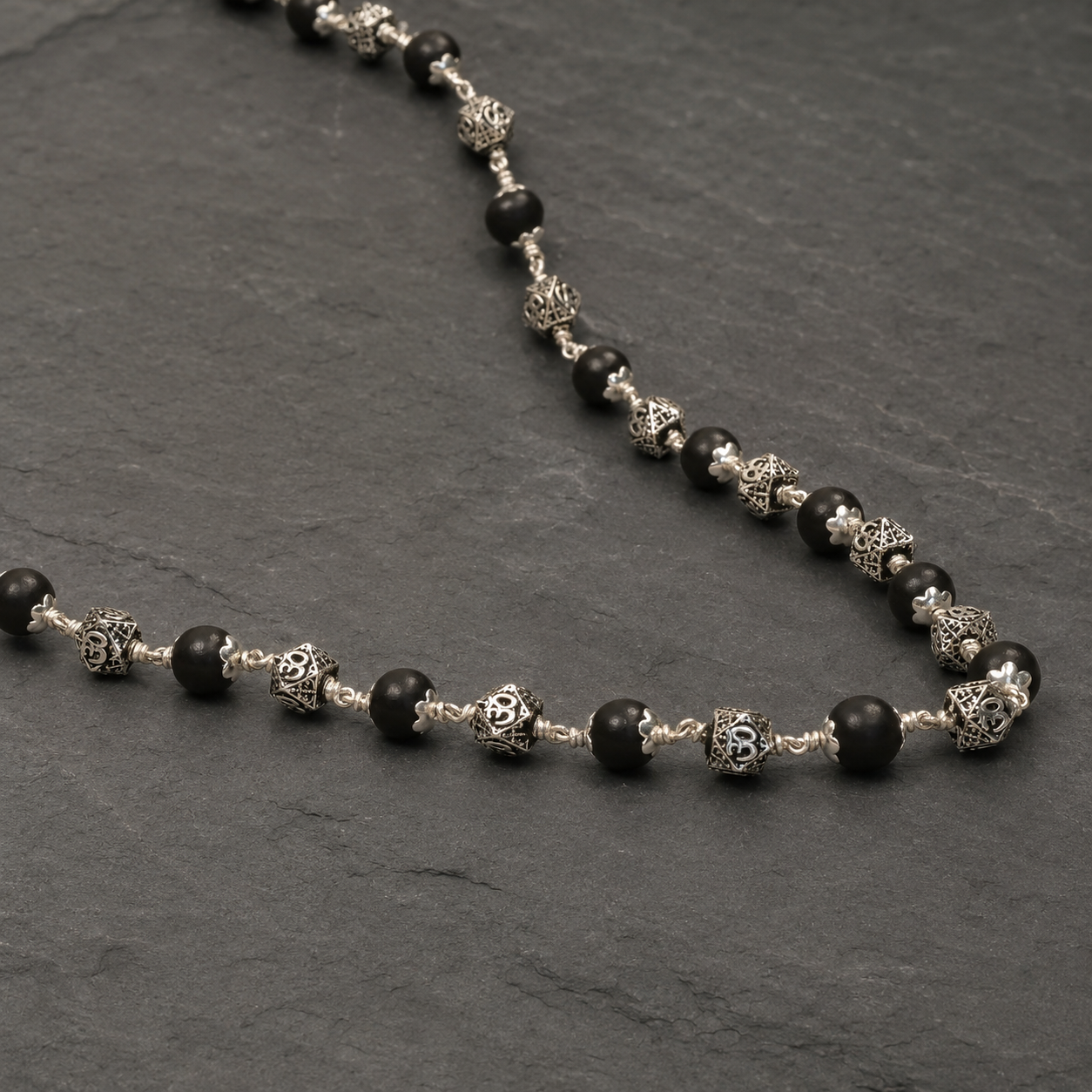 925 silver Karungali Om mala geometric bead close-up