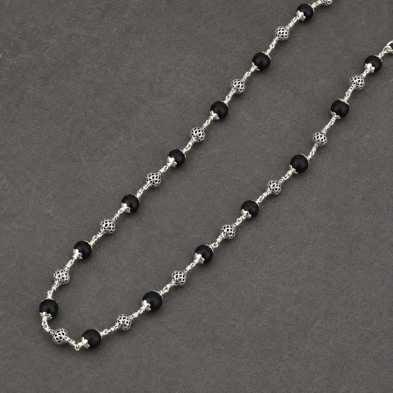925 silver Karungali mala ornate bead craftsmanship close-up