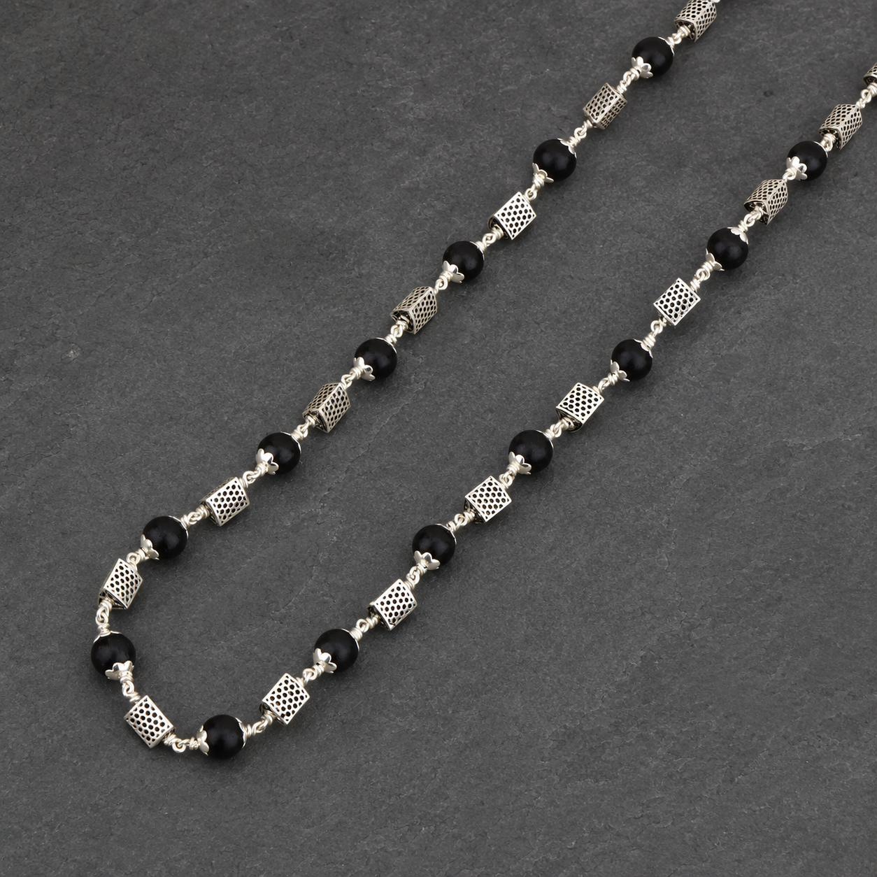 925 silver Karungali mala triangle bead craftsmanship close-up