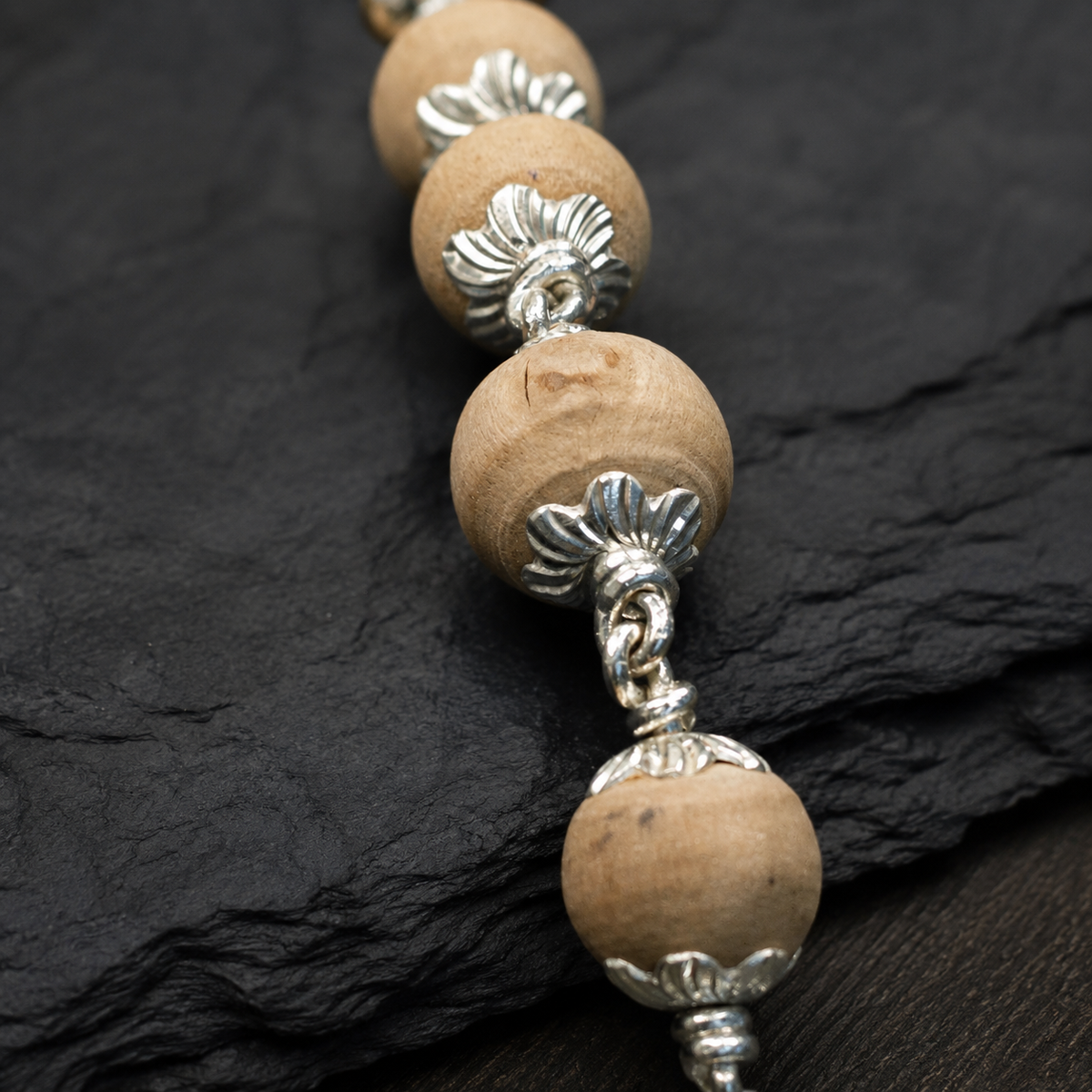 Angled view of premium 925 silver Tulsi Mala