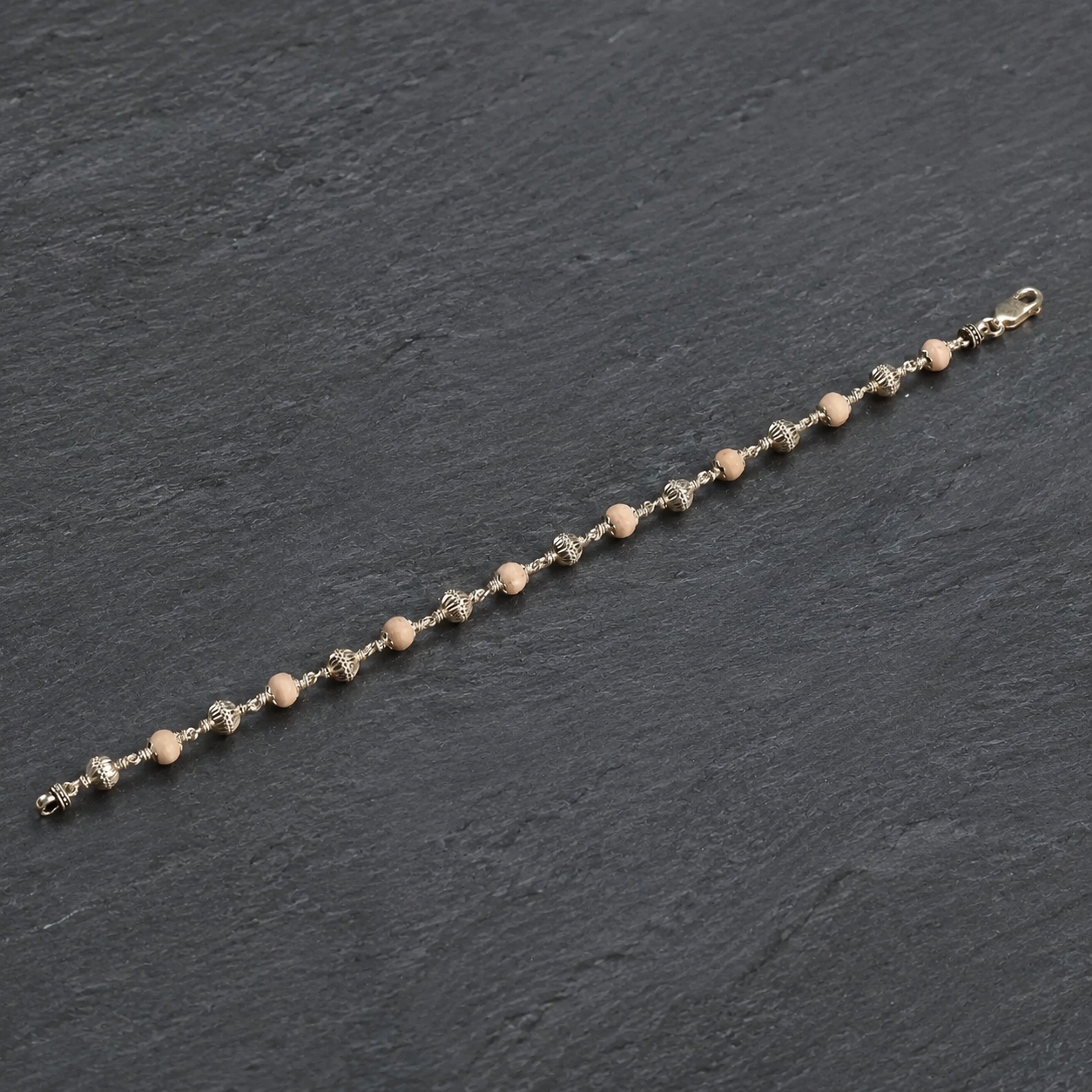 Close-up of 925 silver CNC beads and Tulsi beads