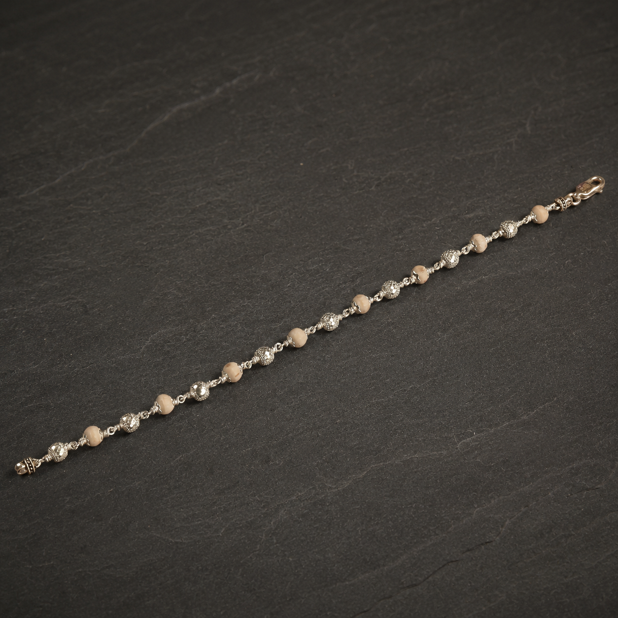 Close-up of 925 silver Om beads and Tulsi beads