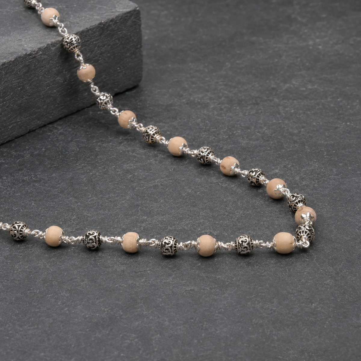 Close-up of engraved Om details on 925 silver beads