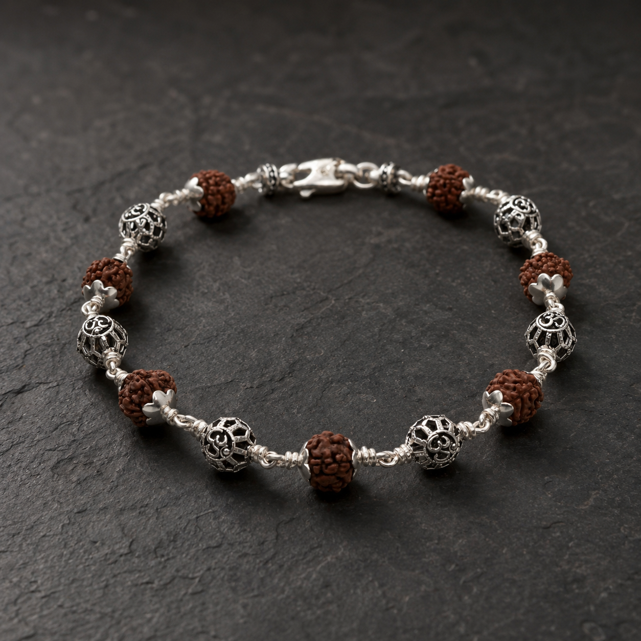 Close-up of polished Round Om sterling silver beads