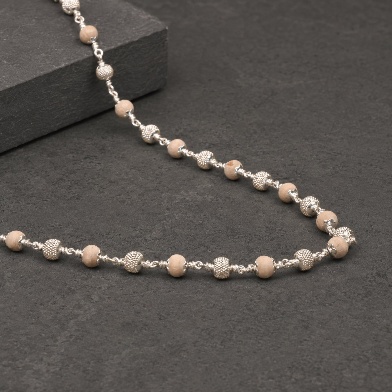 Close-up of precision-cut CNC beads in 925 sterling silver