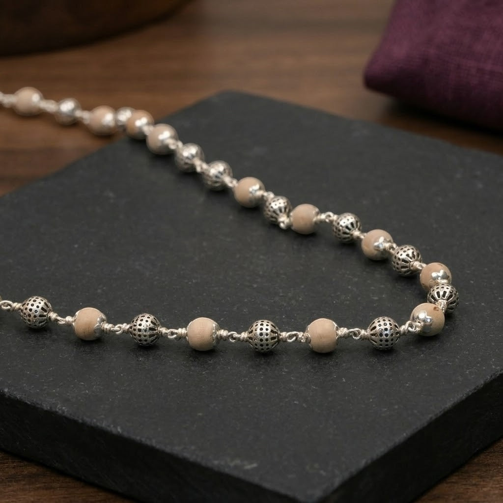 Close-up of round 925 silver beads on Tulsi mala