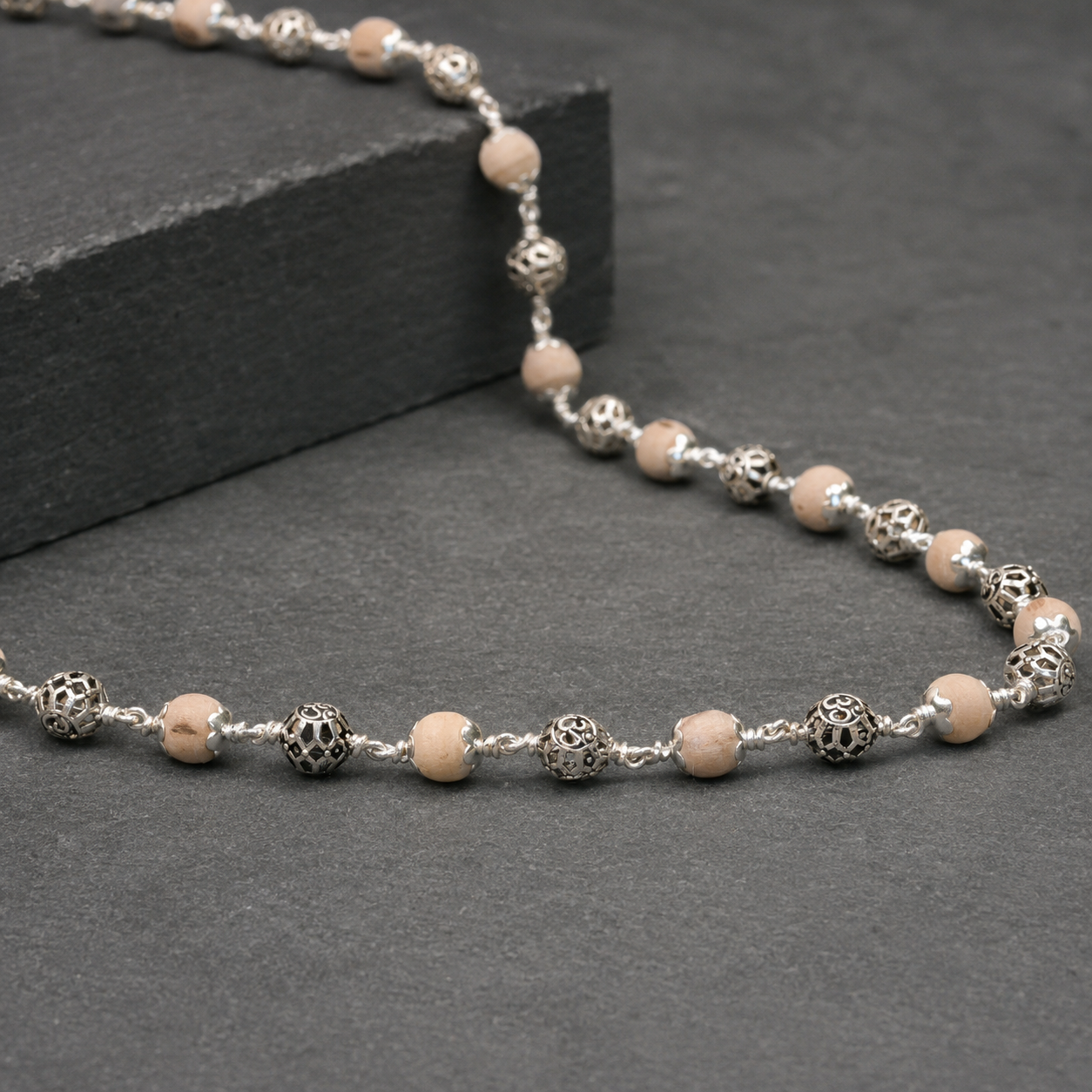 Close-up of round Om engraving on 925 silver beads