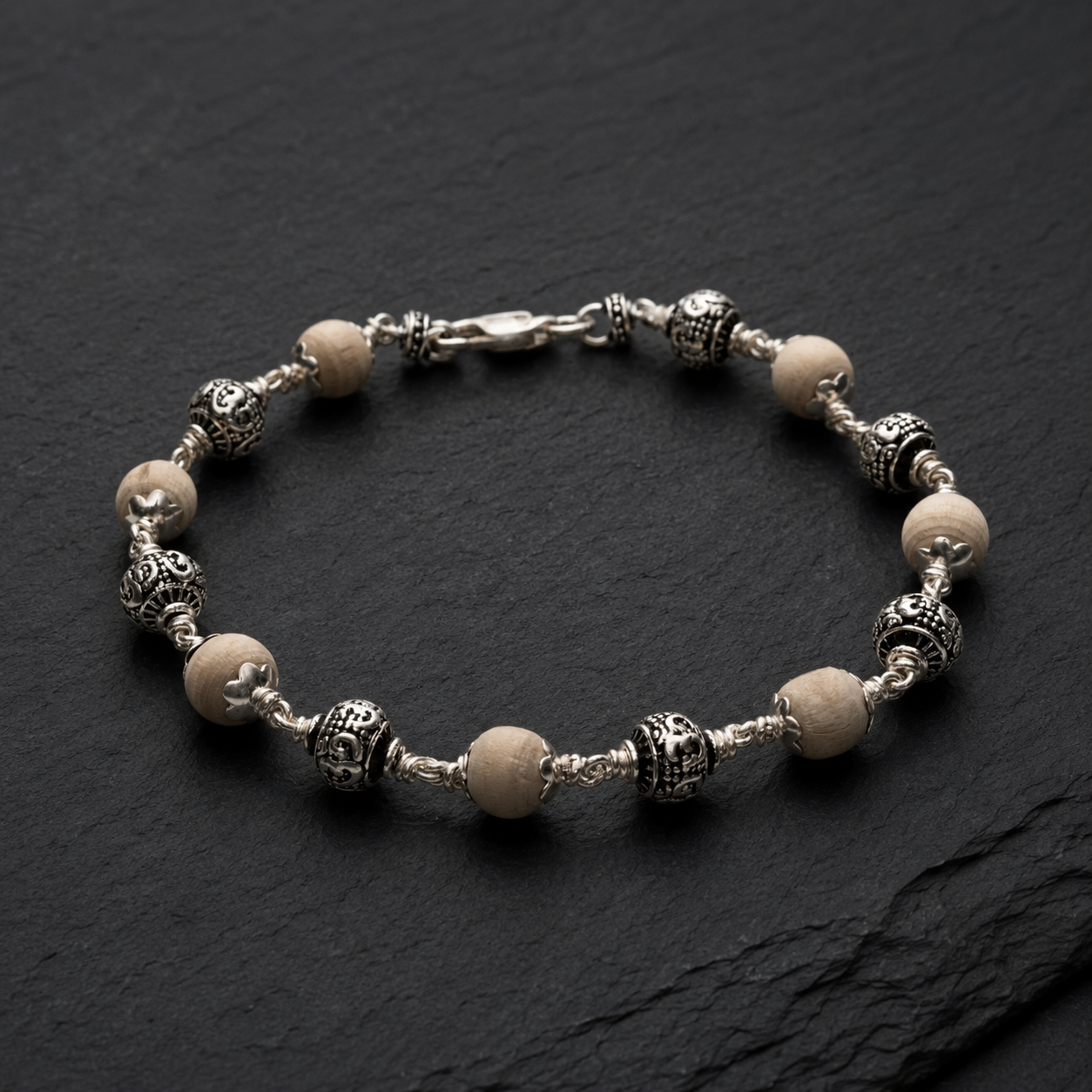 Close-up of sterling silver Om beads on Tulsi bracelet
