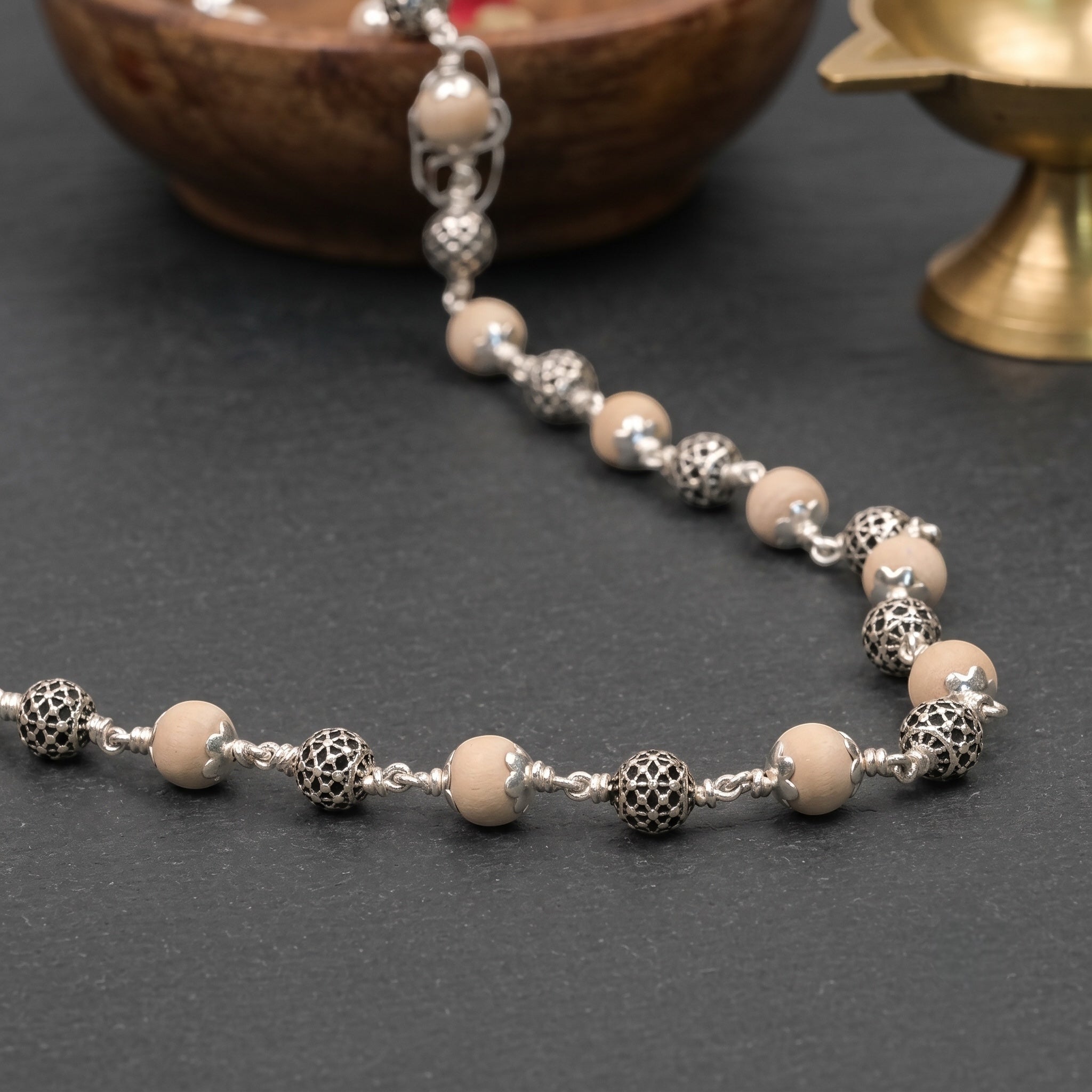 Close-up of round sterling silver beads on Tulsi mala