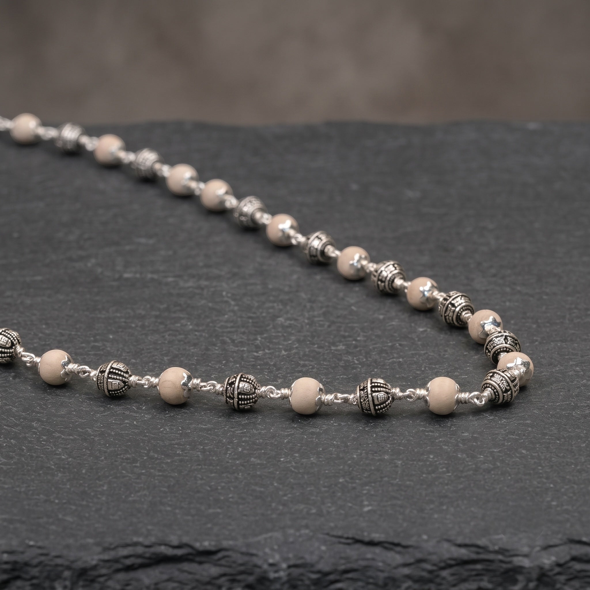 Close-up of sterling silver Shivling beads on Tulsi mala