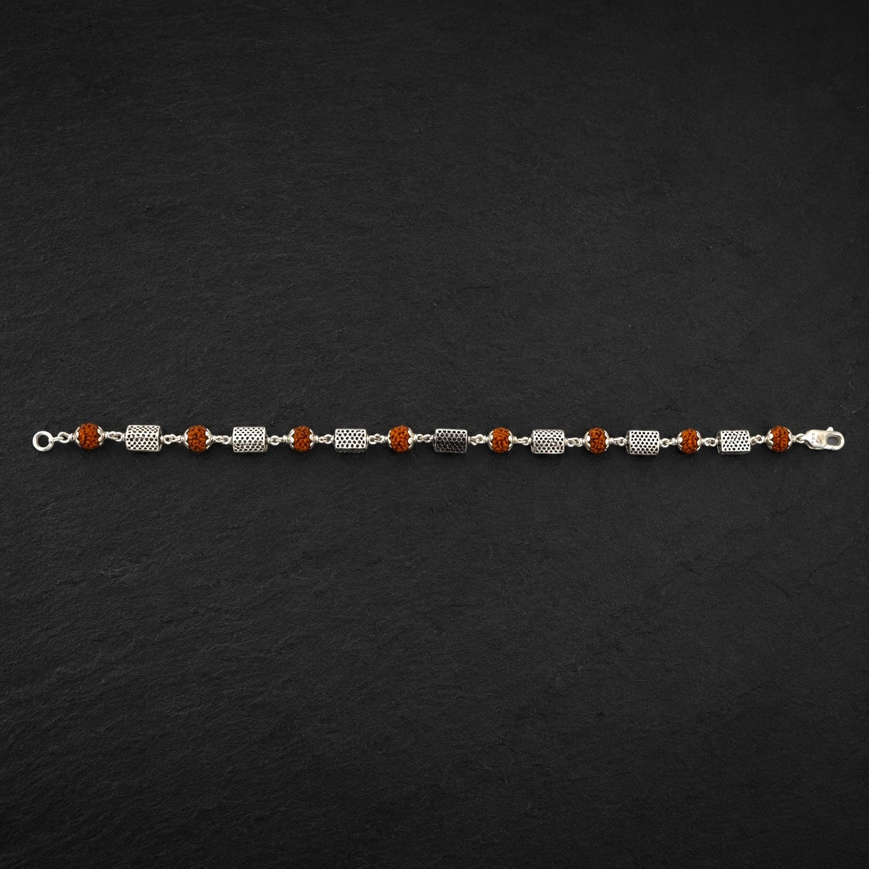 Close-up of geometric sterling silver triangle bracelet beads