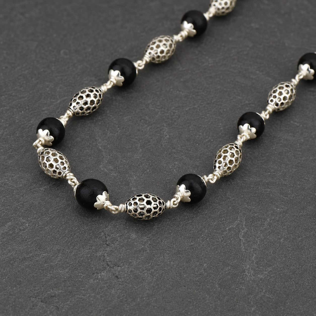 Karungali mala with 925 silver perforated oval beads front view