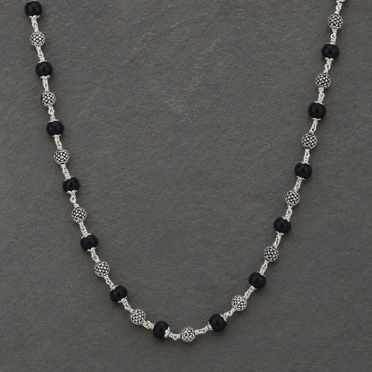 Karungali mala with detailed 925 silver spheres angled view