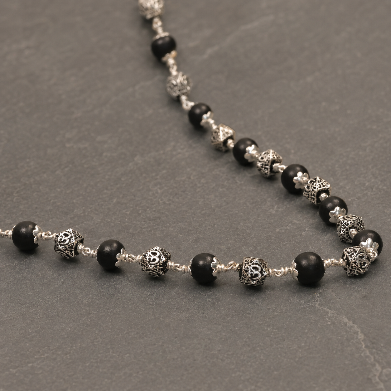 Karungali mala with hexagonal 925 silver Om beads angled view