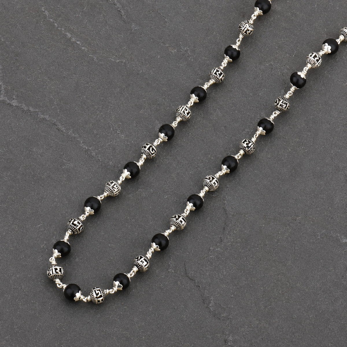 Karungali wood and Lord Ram silver bead close-up