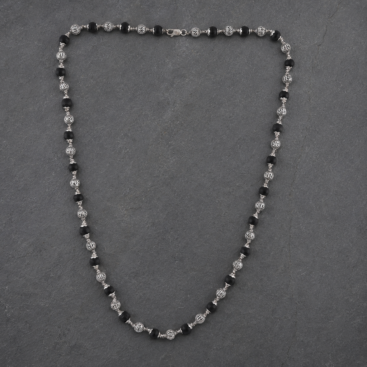 Karungali wood and Shree Hari silver bead close-up