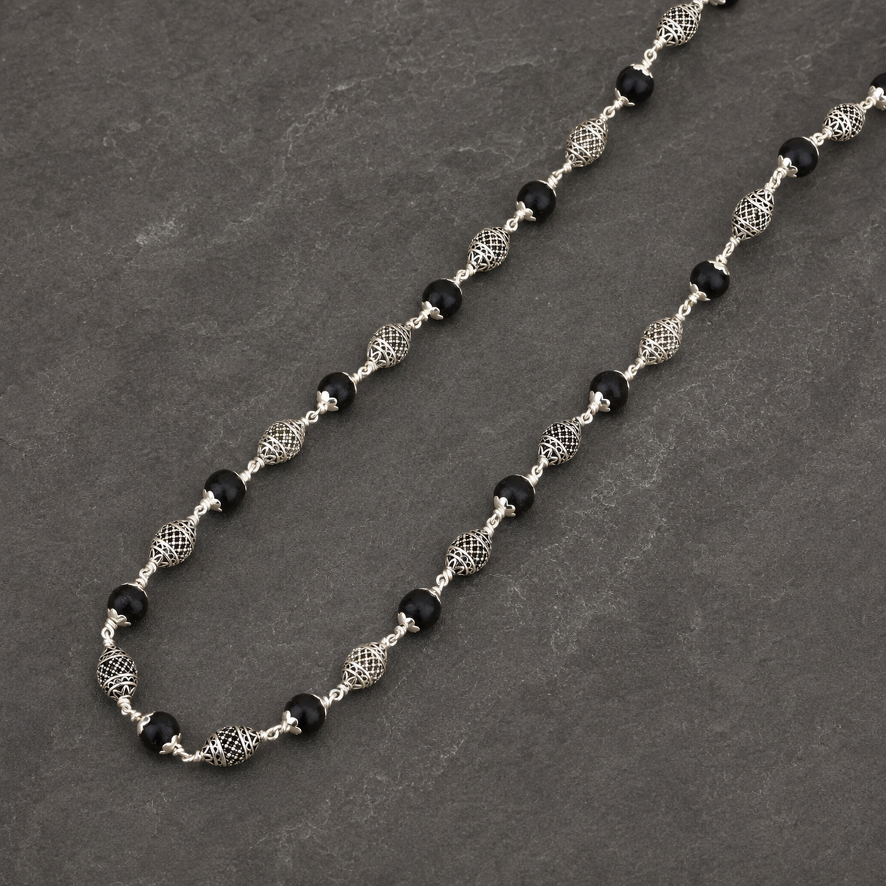 Karungali wood and rounded silver bead close-up