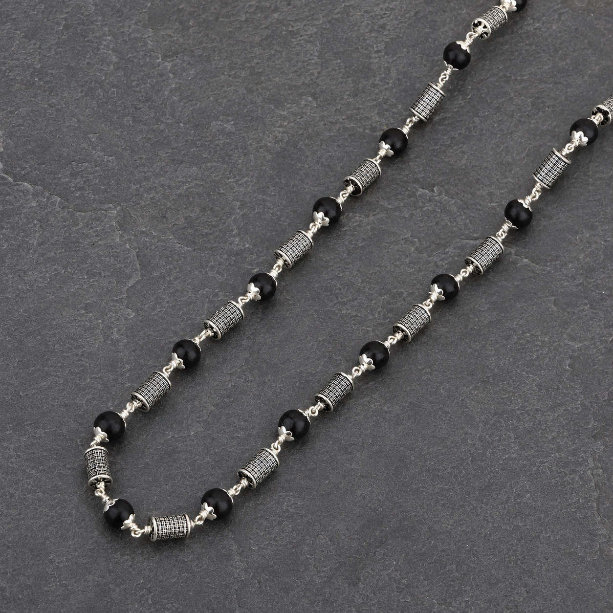 Karungali wood and silver cylinder bead close-up