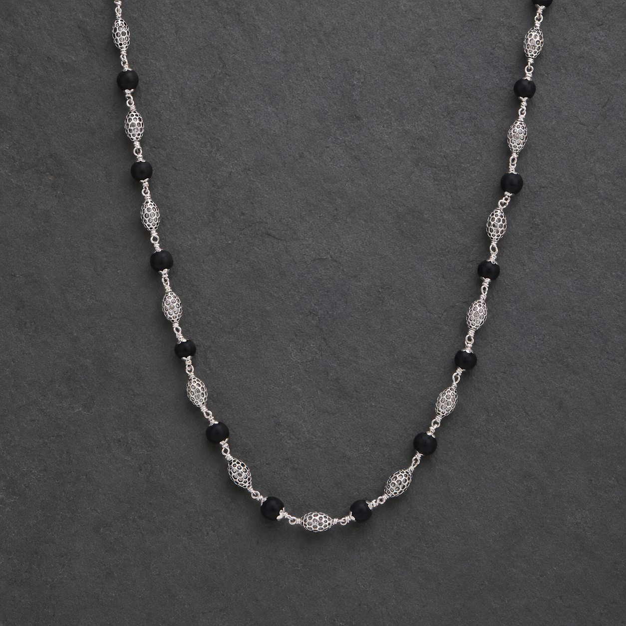 Long Karungali mala with 925 silver oval beads angled view