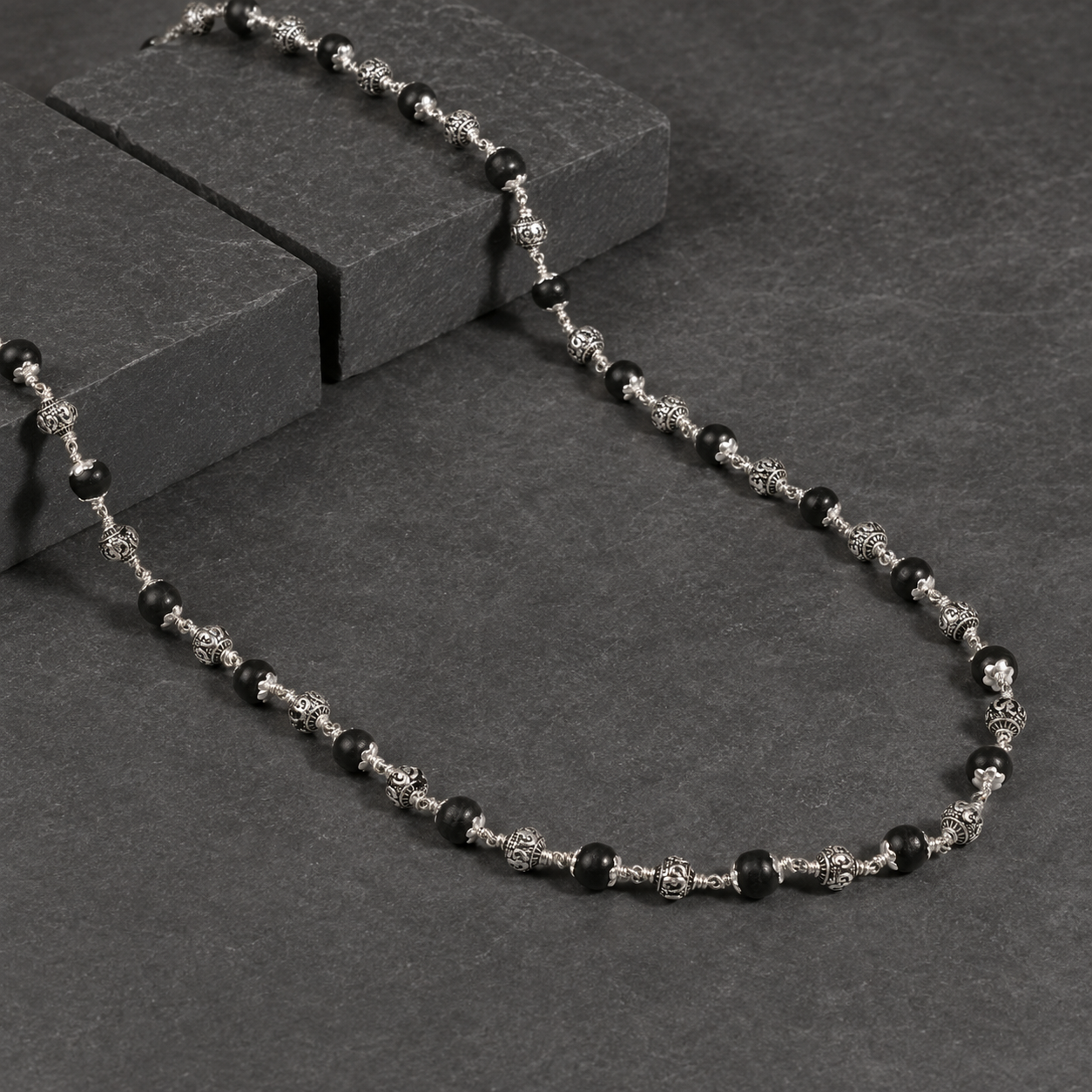 Natural ebony and 925 silver Om bead close-up