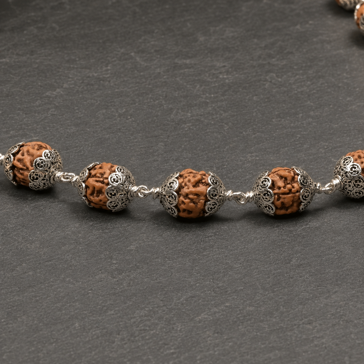 Om patterned 925 silver caps on natural Rudraksha beads